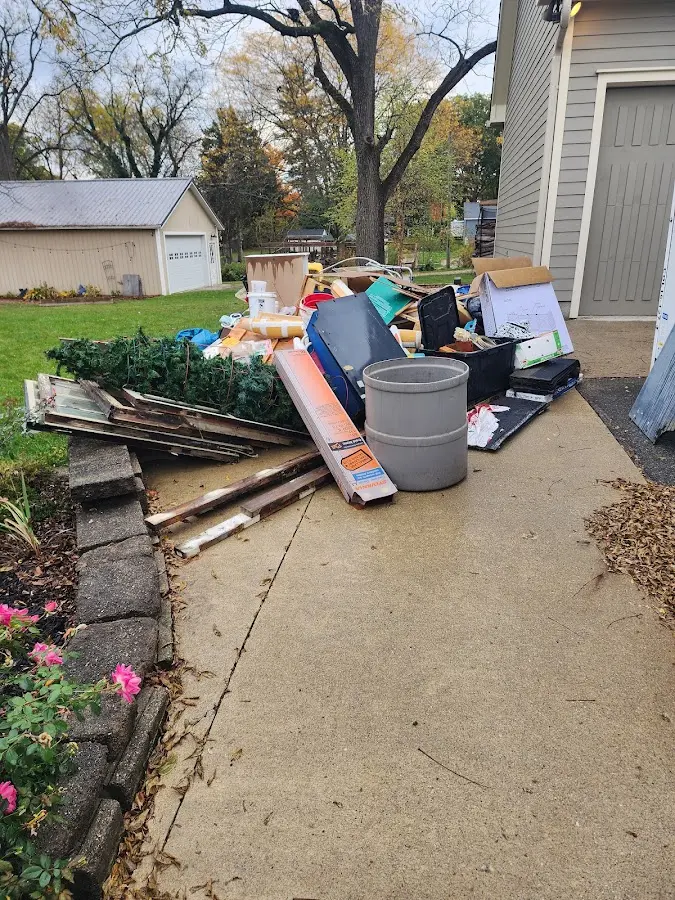 Dumpster being loaded with debris for Roofing Dumpster Rental in Salem Lakes